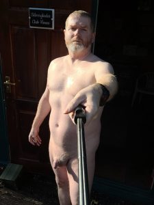 Nude man with beard taking selfie outside Silverglades Club House.